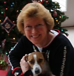 Peg Rhone and dog in front of Christmas Tree